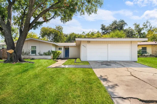 a front view of house with yard and green space