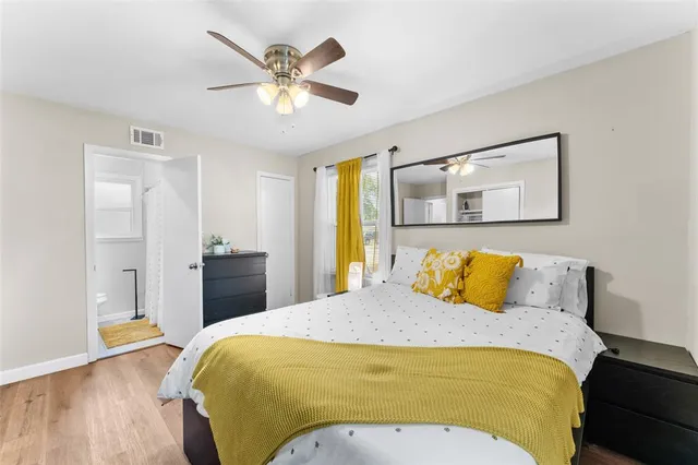 a bedroom with a bed and wooden floor