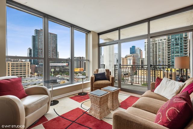 a living room with furniture and a floor to ceiling window