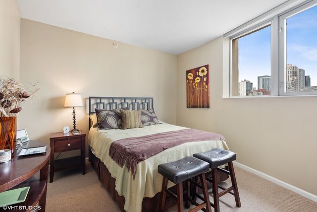 a bedroom with a bed and a mirror