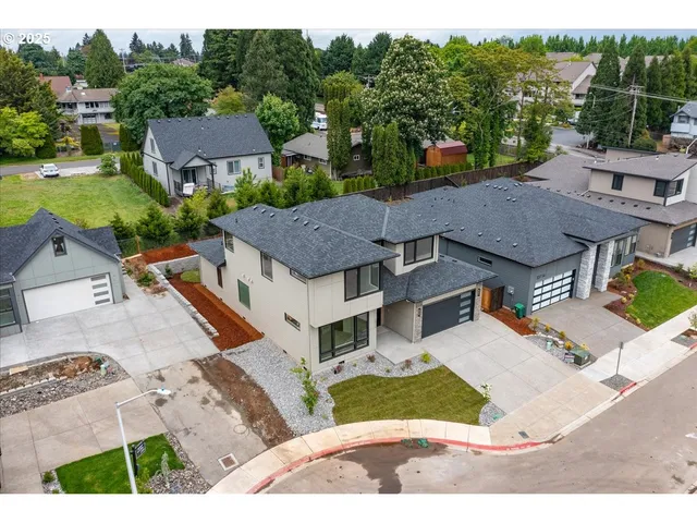 a aerial view of a house with a yard table and chairs