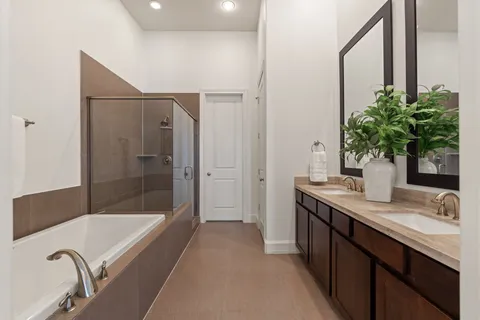 a bathroom with a granite countertop sink a mirror a bathtub and shower