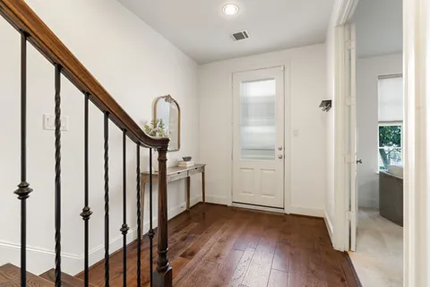 a view of an entryway with wooden floor