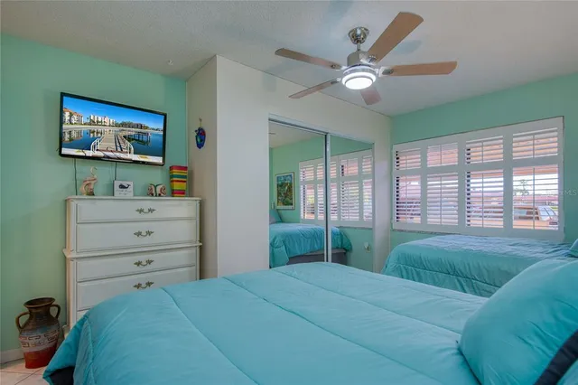 a bedroom with a large bed and a painting on the wall