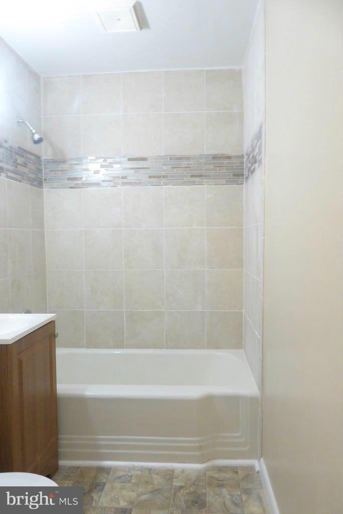 8247 Bullneck Road Baltimore, MD 21222 - Photo 13 of 16 a bathroom with a shower and a bath tub