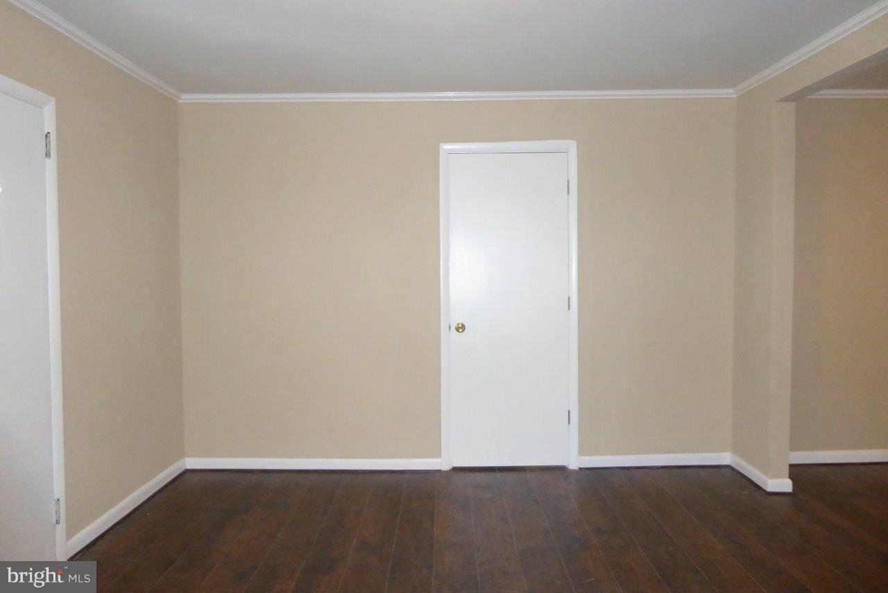 8247 Bullneck Road Baltimore, MD 21222 - Photo 5 of 16 a view of an empty room with wooden floor
