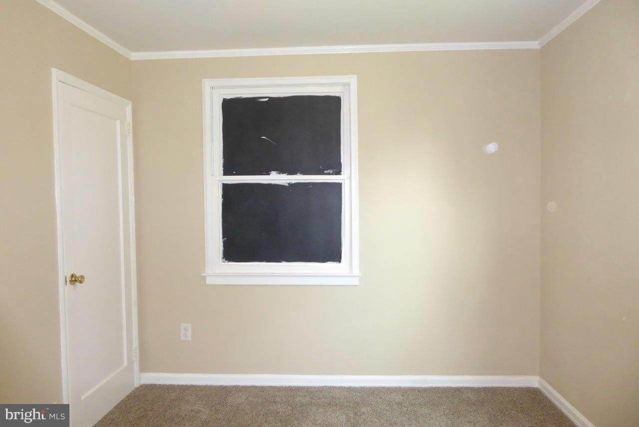 8247 Bullneck Road Baltimore, MD 21222 - Photo 7 of 16 a view of an empty room with a mirror