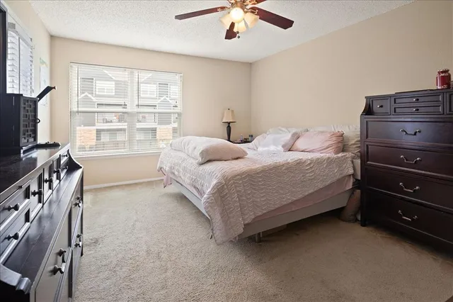 a bedroom with a bed and a dresser