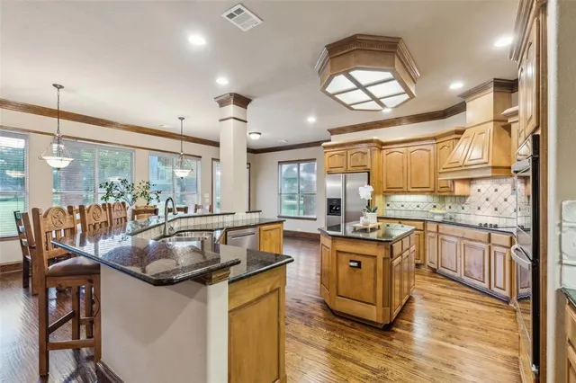a kitchen with granite countertop a stove and a sink