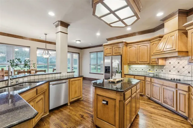 a kitchen with stainless steel appliances granite countertop a stove and a sink