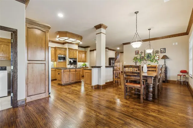 a kitchen with stainless steel appliances a refrigerator and wooden floor