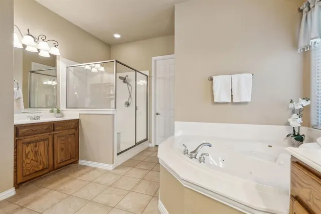 a bathroom with a tub sink and mirror