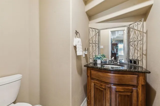 a bathroom with a sink a toilet and mirror