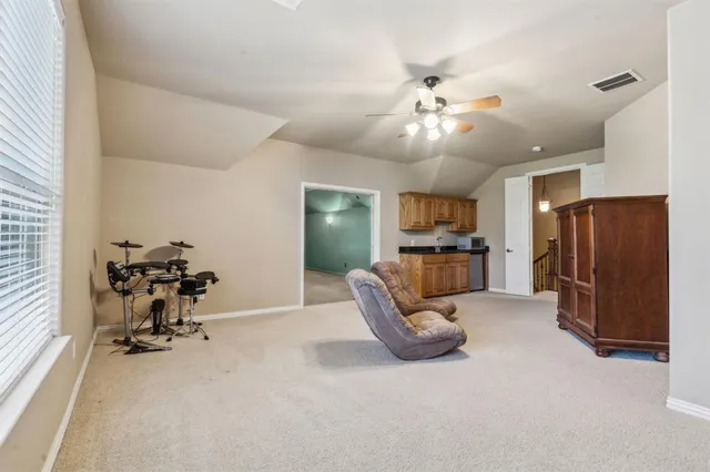 a view of a livingroom with furniture and a ceiling fan