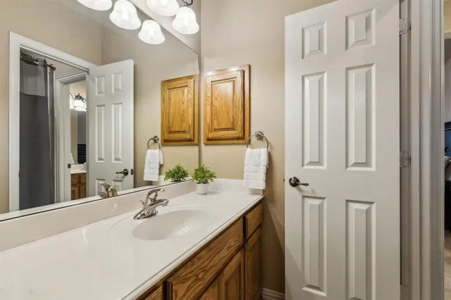 a bathroom with a sink vanity and a mirror