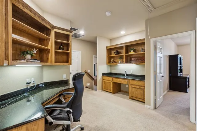 a kitchen with granite countertop a stove a sink and a refrigerator