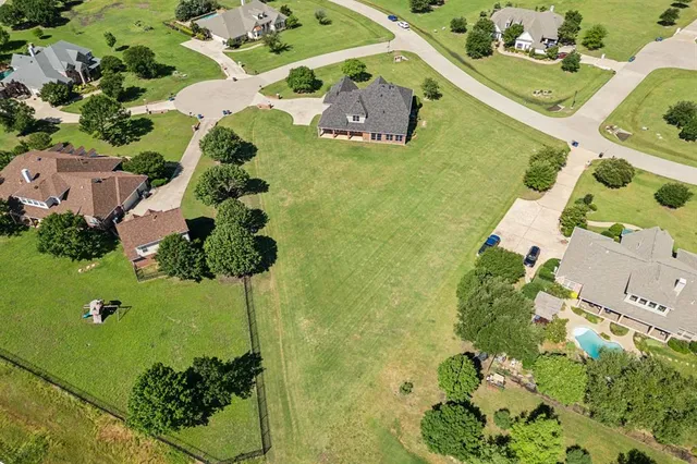 an aerial view of a house with a yard and plants