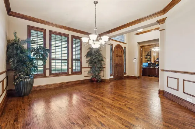 a view of a room with wooden floor and windows