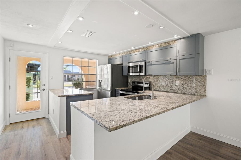 4127 Stratford Drive, Unit 4127 New Port Richey, FL 34652 - Photo 11 of 45 a kitchen with a stove and a sink