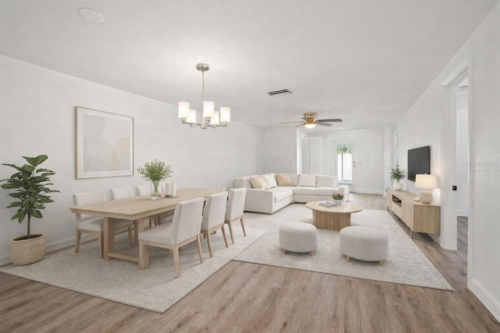 4127 Stratford Drive, Unit 4127 New Port Richey, FL 34652 - Photo 12 of 45 a living room with lots of white furniture and a chandelier