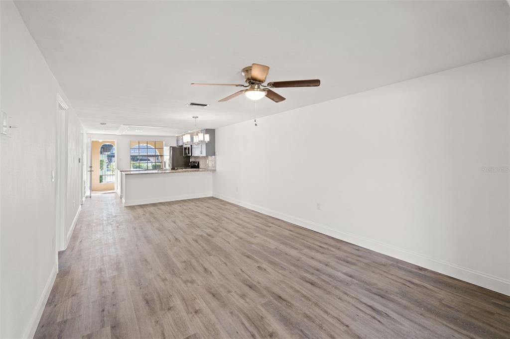4127 Stratford Drive, Unit 4127 New Port Richey, FL 34652 - Photo 13 of 45 wooden floor in an empty room with a window