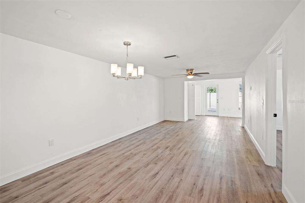 4127 Stratford Drive, Unit 4127 New Port Richey, FL 34652 - Photo 14 of 45 wooden floor in an empty room with a window