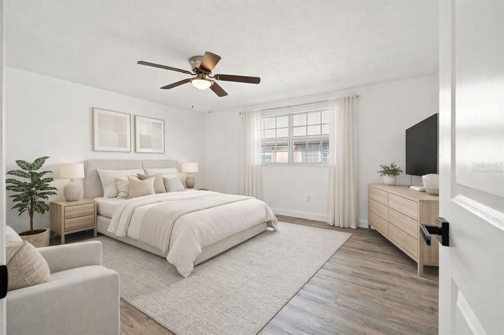 4127 Stratford Drive, Unit 4127 New Port Richey, FL 34652 - Photo 16 of 45 a bedroom with a bed and a flat screen tv