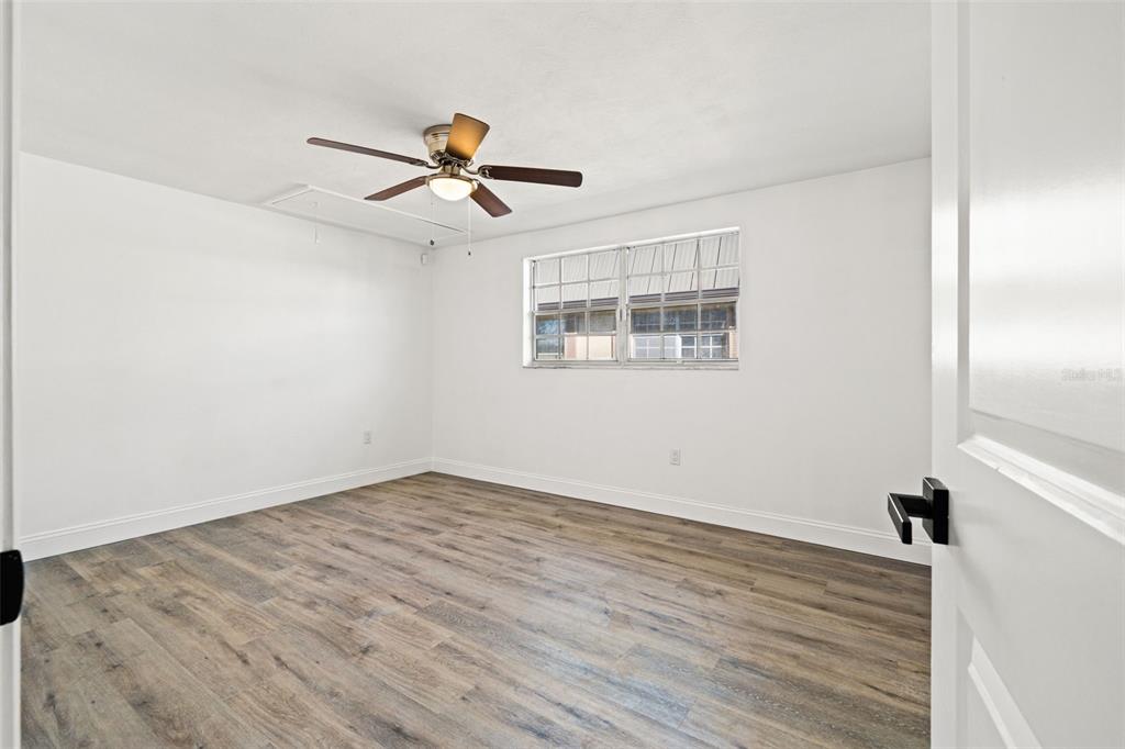 4127 Stratford Drive, Unit 4127 New Port Richey, FL 34652 - Photo 17 of 45 a view of empty room with wooden floor and fan