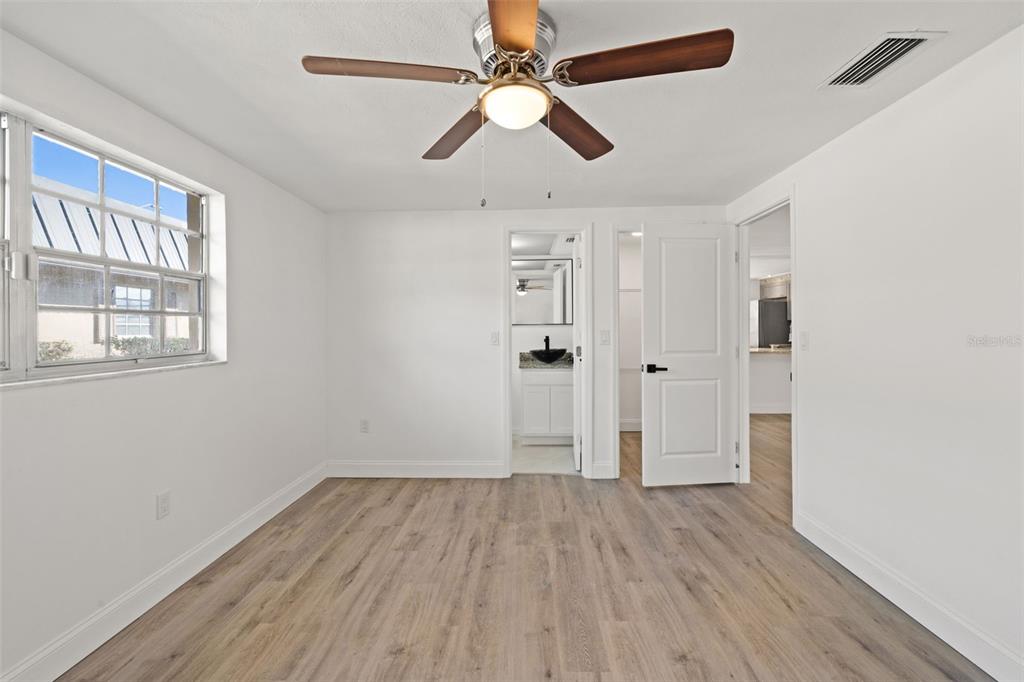 4127 Stratford Drive, Unit 4127 New Port Richey, FL 34652 - Photo 18 of 45 wooden floor in an empty room with a window