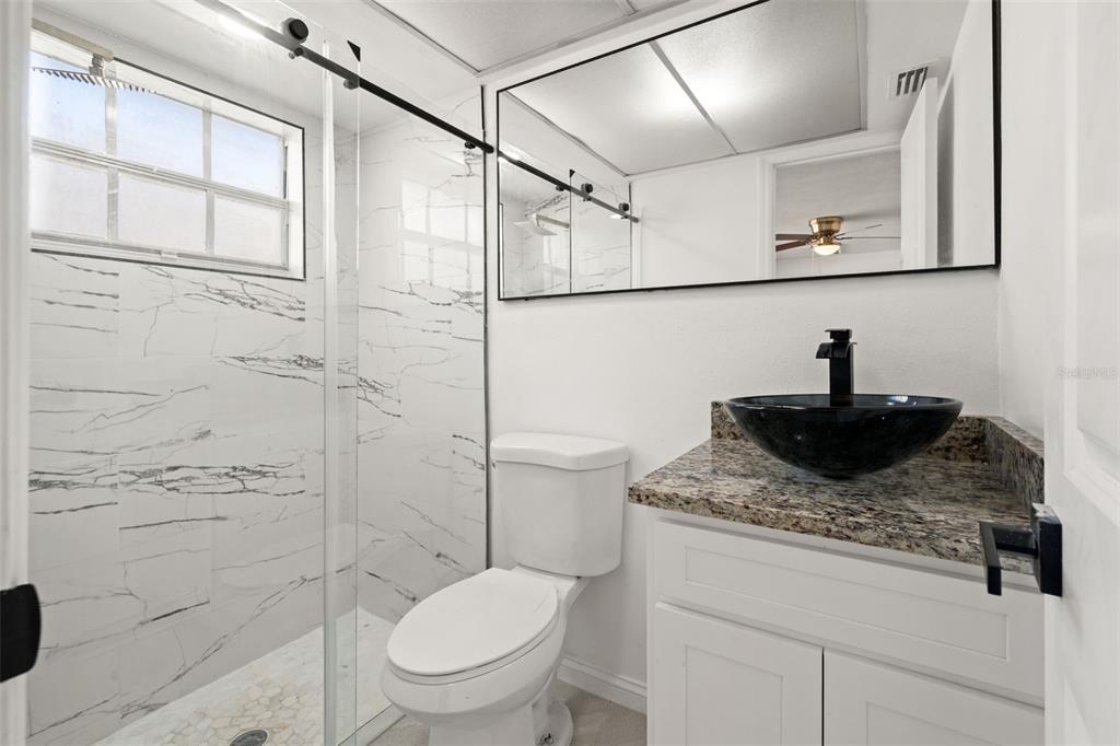 4127 Stratford Drive, Unit 4127 New Port Richey, FL 34652 - Photo 19 of 45 a bathroom with a sink a toilet and shower