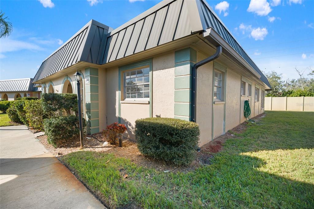 4127 Stratford Drive, Unit 4127 New Port Richey, FL 34652 - Photo 2 of 45 a front view of a house with garden