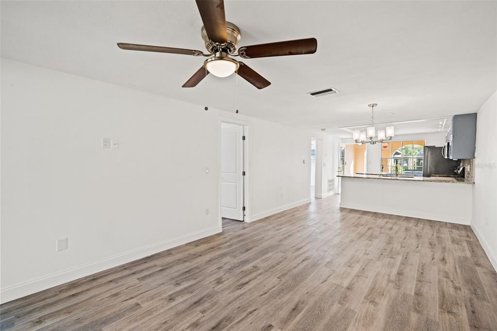 4127 Stratford Drive, Unit 4127 New Port Richey, FL 34652 - Photo 21 of 45 a view of a kitchen with wooden floor a sink and a window