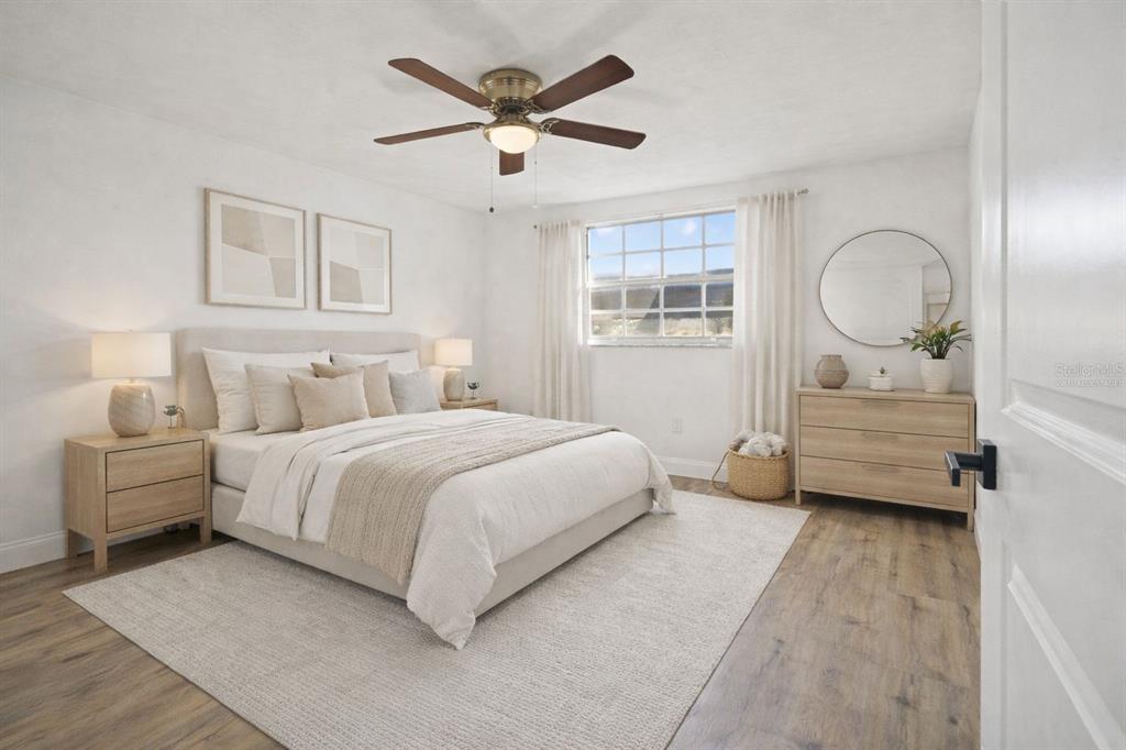 4127 Stratford Drive, Unit 4127 New Port Richey, FL 34652 - Photo 23 of 45 a bedroom with a bed mirror and window