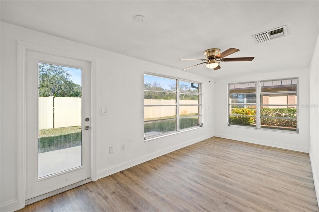 4127 Stratford Drive, Unit 4127 New Port Richey, FL 34652 - Photo 27 of 45 an empty room with wooden floor and windows