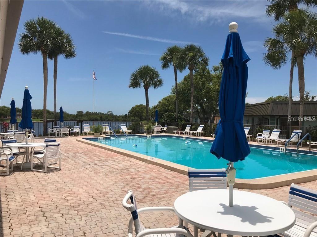 4127 Stratford Drive, Unit 4127 New Port Richey, FL 34652 - Photo 42 of 45 a swimming pool with outdoor seating and yard