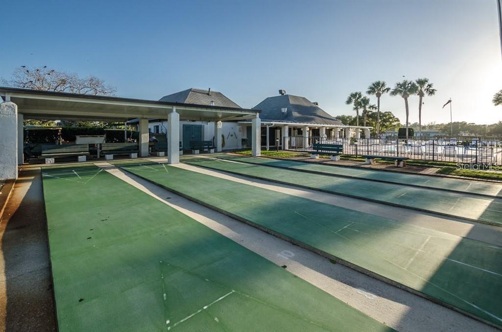 4127 Stratford Drive, Unit 4127 New Port Richey, FL 34652 - Photo 44 of 45 a front view of a house with a yard table and chairs