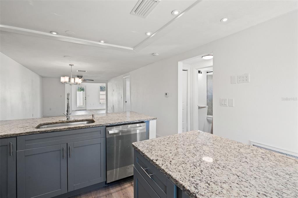 4127 Stratford Drive, Unit 4127 New Port Richey, FL 34652 - Photo 7 of 45 a bathroom with a granite countertop sink and a mirror