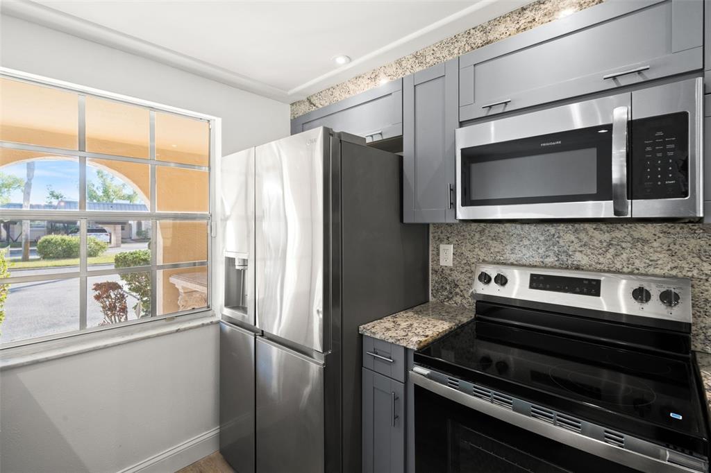 4127 Stratford Drive, Unit 4127 New Port Richey, FL 34652 - Photo 8 of 45 a kitchen with appliances a sink and a window