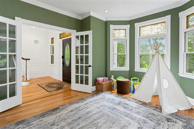 a living room with furniture and wooden floor