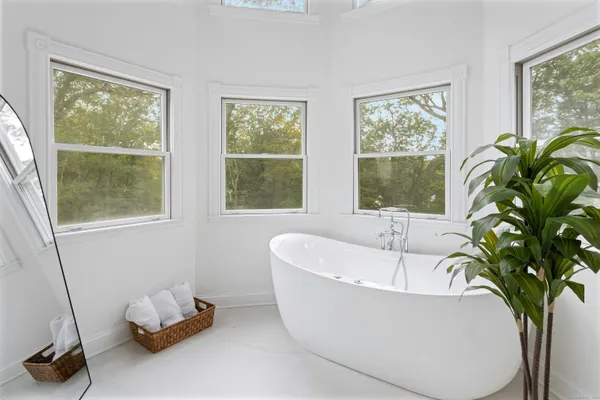 a white bath tub sitting next to a window