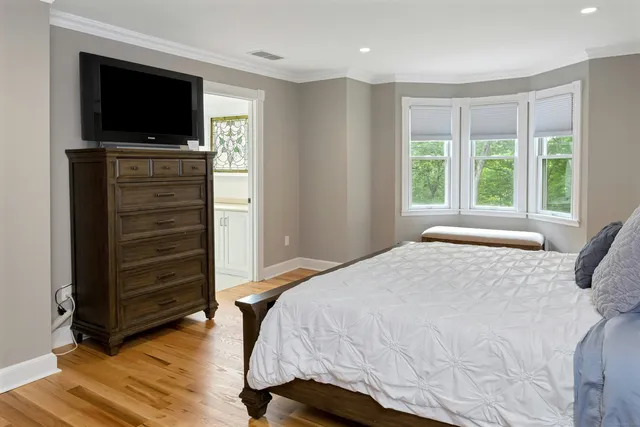 a bedroom with a bed and a television