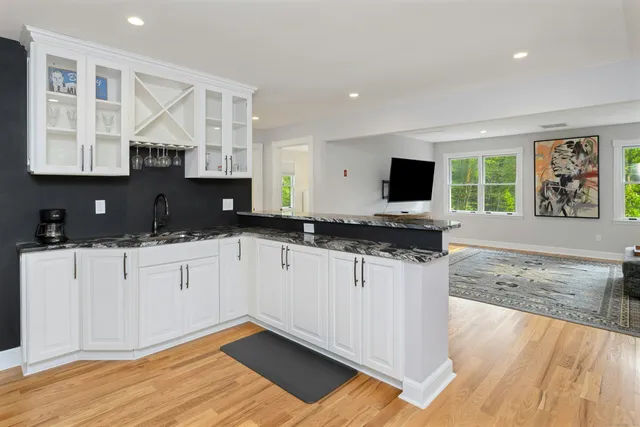 a kitchen with granite countertop a stove a sink and a granite counter tops