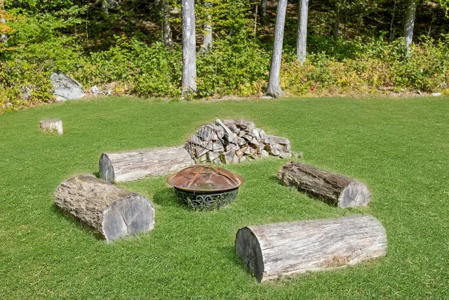 a couple of table and chairs sitting in the grass