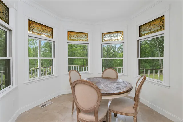 a view of a dining room with furniture window and outside view