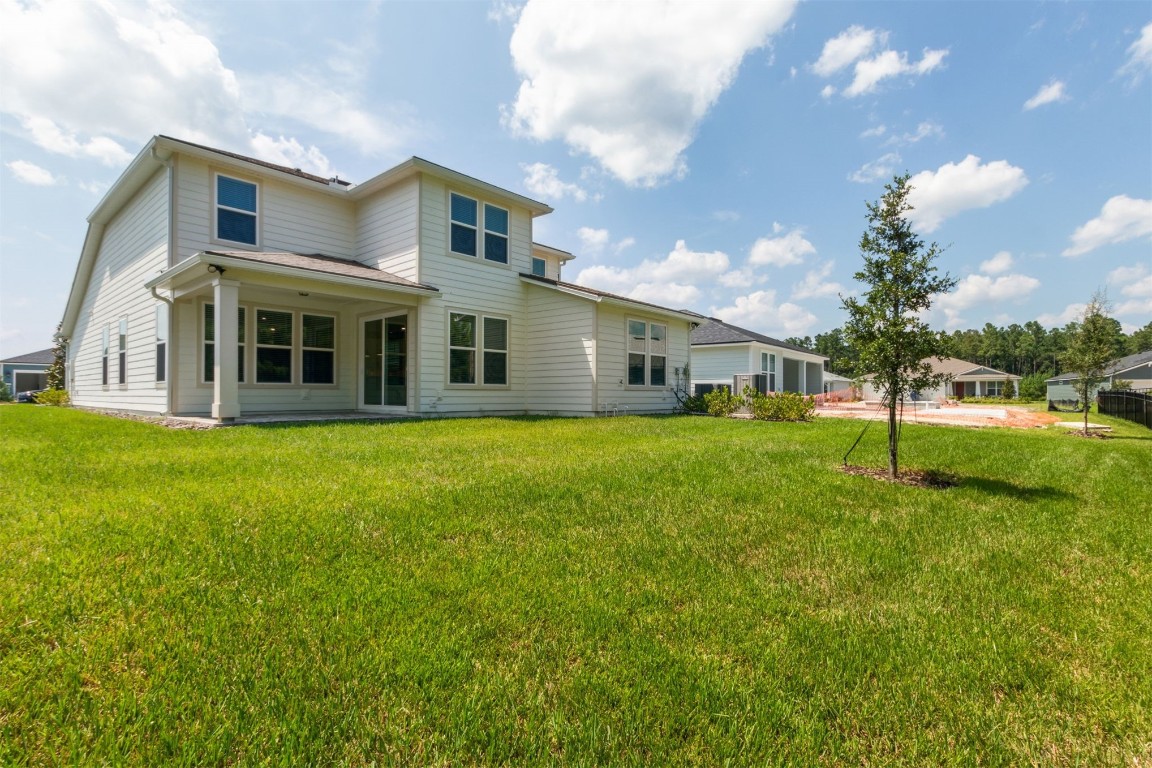 840 Continuum Loop Yulee, FL 32097 - Photo 11 of 64 a front view of house with yard and green space
