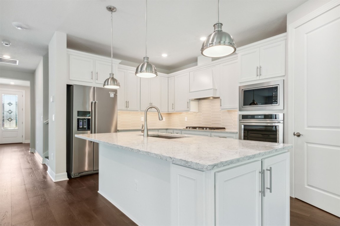 840 Continuum Loop Yulee, FL 32097 - Photo 2 of 64 a kitchen with a stove a sink and a refrigerator