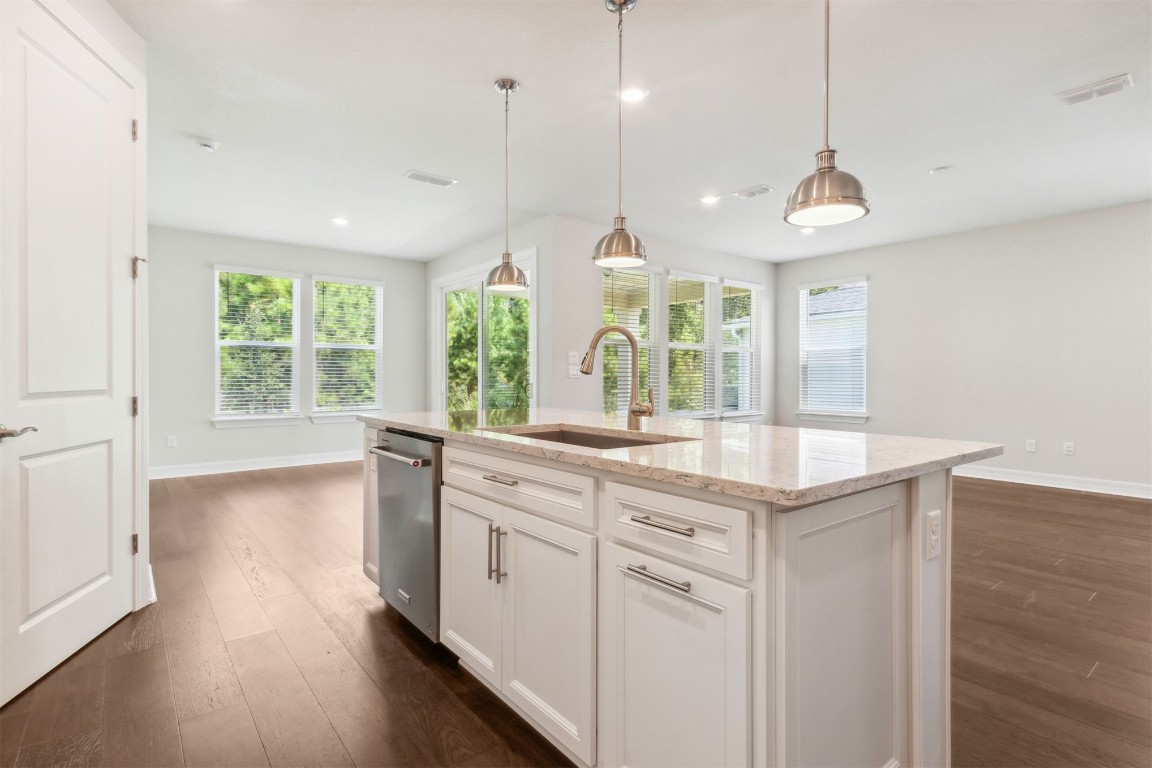840 Continuum Loop Yulee, FL 32097 - Photo 26 of 64 a open kitchen with a large window a oven a stove and a wooden floors