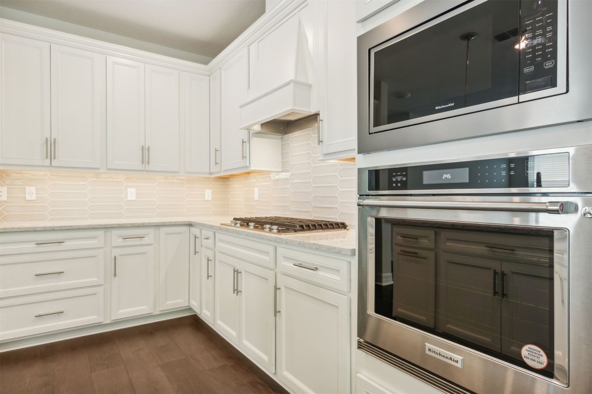 840 Continuum Loop Yulee, FL 32097 - Photo 27 of 64 a kitchen with cabinets stainless steel appliances and sink