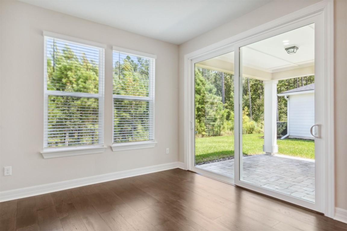 840 Continuum Loop Yulee, FL 32097 - Photo 29 of 64 a view of an empty room with wooden floor and a window