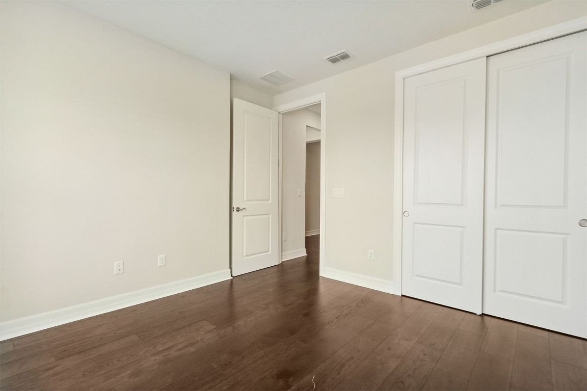 840 Continuum Loop Yulee, FL 32097 - Photo 35 of 64 a view of an empty room with wooden floor